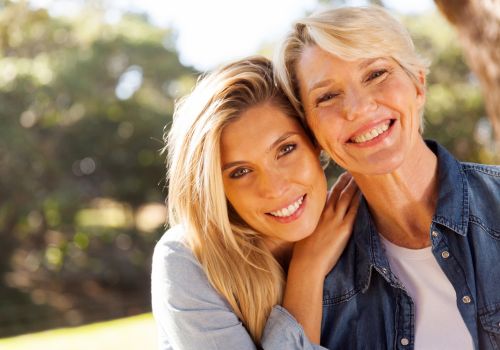 Two smiling midlife women  in nature enjoying an active lifestyle and supporting each other during menopause