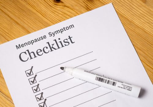 Checklist and pen on a desk symbolizing practical steps women can take to prepare for menopause and support wellbeing.