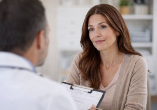 Woman discussing menopause symptoms with her doctor