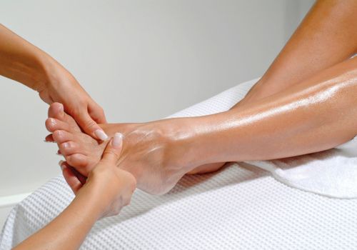 woman massaging foot for deep hydration and nourishment after 40